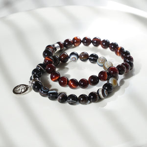 Banded Agate and TIger Eye gemstone bracelets with silver charms by Gems In Style Jewellery. 